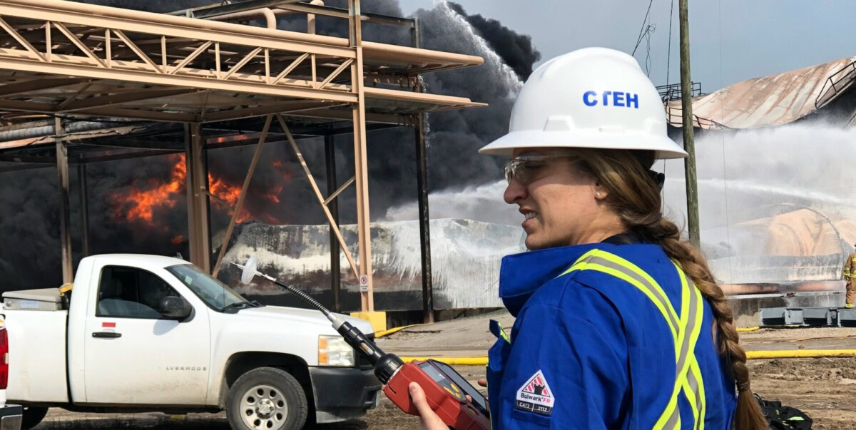 A person in protective gear with a hard hat labeled 